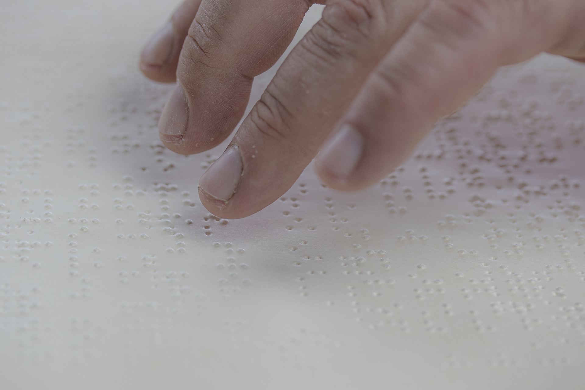 myriams-fotos-braille-5496083_1920 Person reading embossed braille text